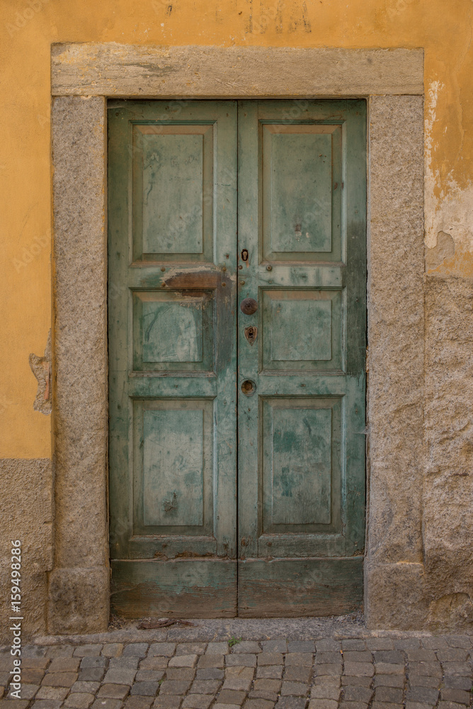 Old door in Tirano in Italy