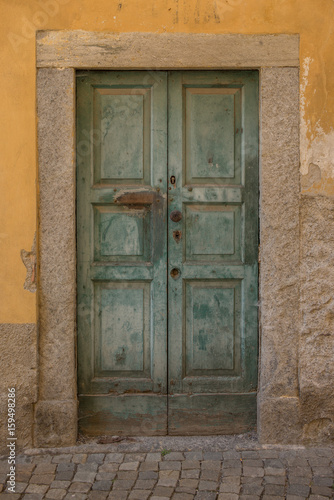 Old door in Tirano in Italy