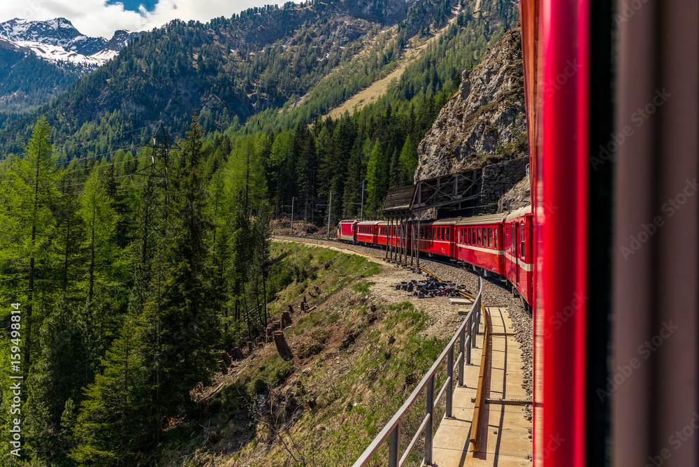 Red train slowly climbing to the Bernina Pass in the Swiss Alps - 2 Red train slowly climbing to the Bernina Pass in the Swiss Alps - 2