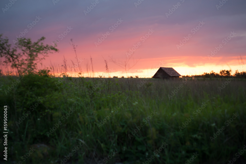 simple rural house at sunset