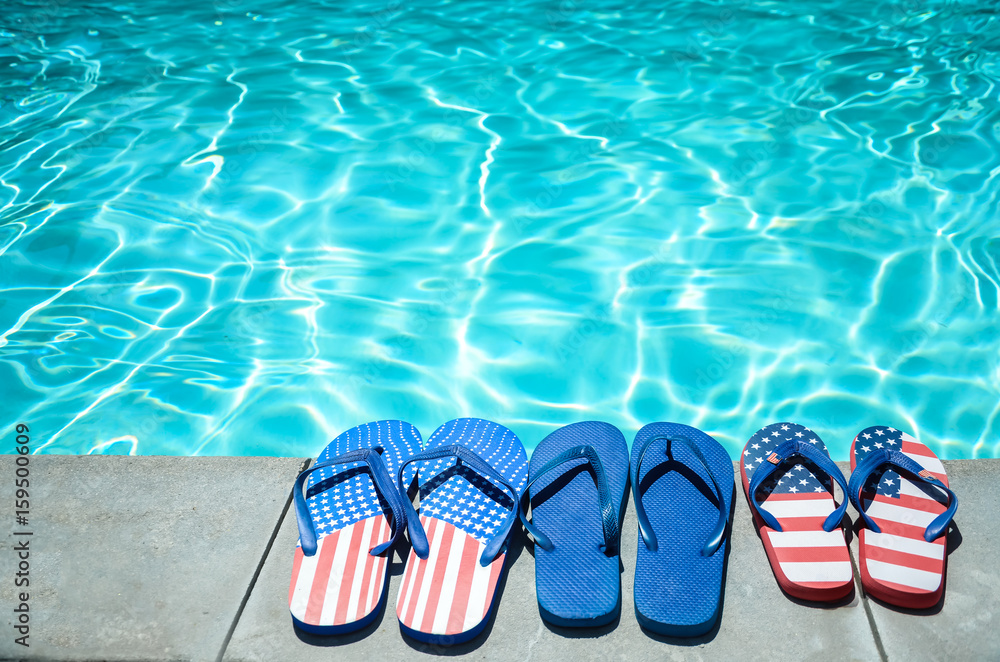 Naklejka premium Summer background with flip flops near the pool
