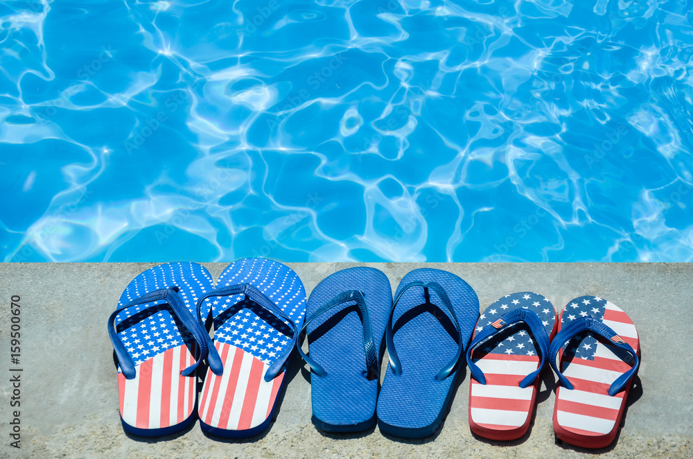 Obraz premium Summer background with flip flops near the pool
