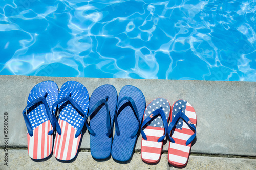 Summer background with flip flops near the pool