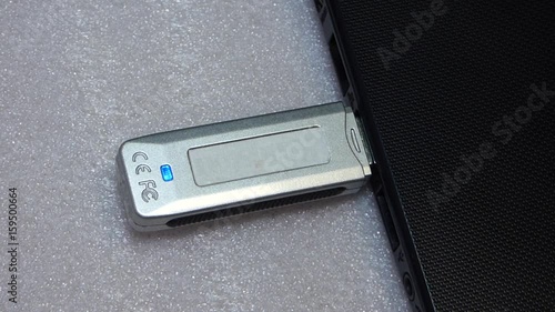 Flash drive connection to laptop, close up view. Caucasian man insert device in computer and then remove it.