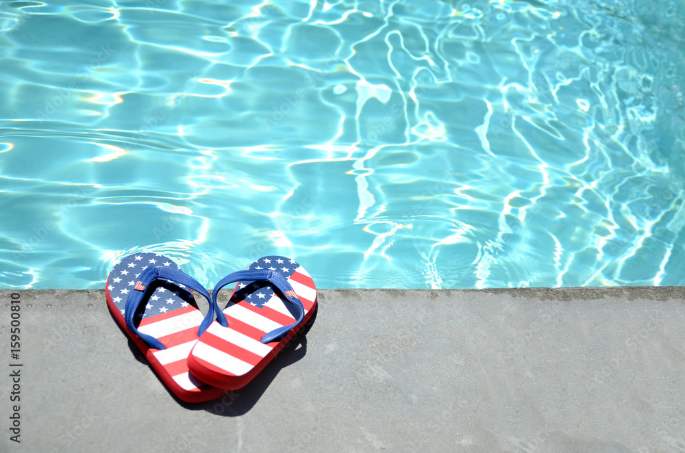Naklejka premium Summer background with flip flops near the pool