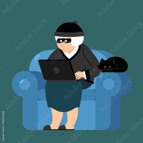 Grandmother hacker sits on an armchair with laptop and cat. grandma is thief programmer. internet Computer security. Old woman and PC