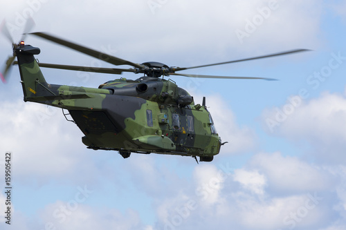 Modern tactical helicopter flying away.