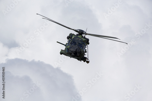Modern tactical helicopter flying towards the camera.
