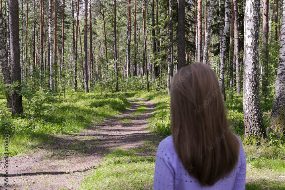 The girl is looking at a beautiful forest. The girl is looking at a beautiful forest.