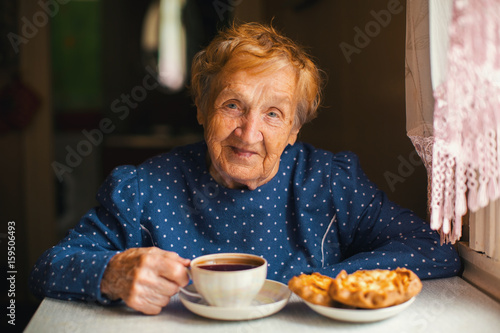Portrait of an elderly villager women drinking tea.