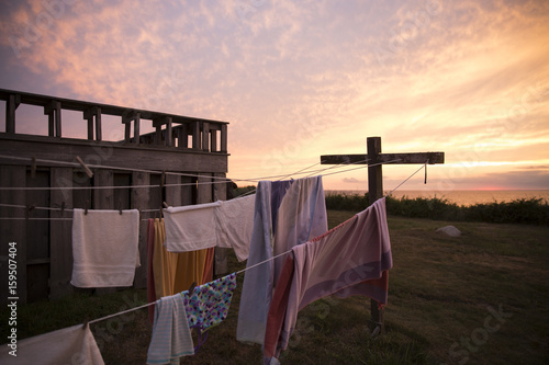 beach towels and laundry hung on a lin at sunset.
