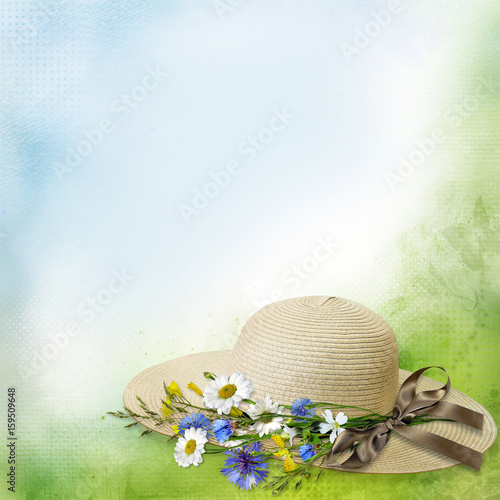 Fototapeta Naklejka Na Ścianę i Meble -  Female straw hat with ribbon and bouquet of flowers on a gentle vintage background with space for text or photo