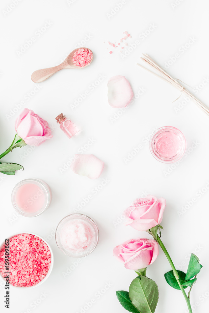 cosmetic set with rose blossom and body cream on white desk background top view cosmetic set with rose blossom and body cream on white desk background top view