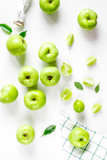 natural food design with green apples white desk background top view