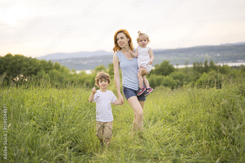 young mother with their cute daughter and son young mother with their cute daughter and son