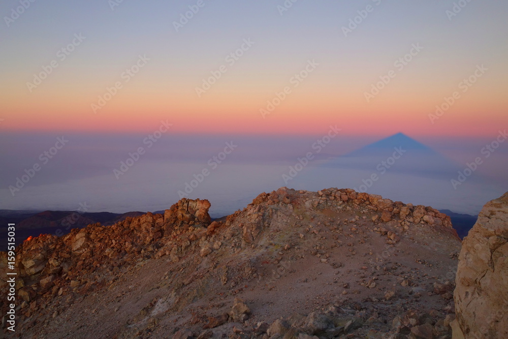 Teide Peak (the highest point in Spain - 3718 metres) casting its shadow like a pyramid at the sunrise, Tenerife, Canary islands, Spain