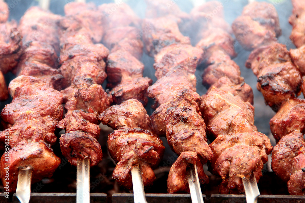 the meat on the skewers on the grill. 