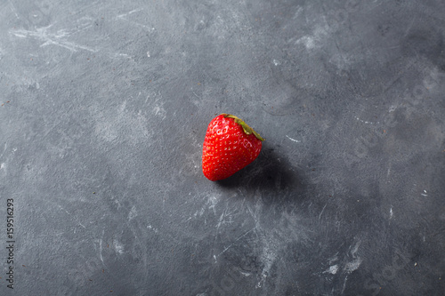 Strawberry. Fresh strawberry on dark background . Red strawberry. Loosely laid strawberries in different positions. Copyspace.