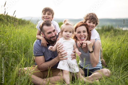 Happy family in the meadow photo