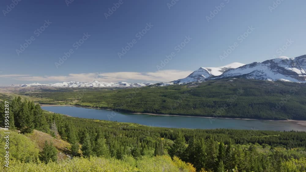 Wide panning shot of green valley and mountains. Glacier National Park, Montana, United States Wide panning shot of green valley and mountains. Glacier National Park, Montana, United States