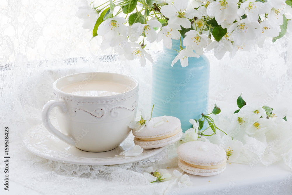 cup of coffee and pink cherry blossoms on a white background cup of coffee and pink cherry blossoms on a white background