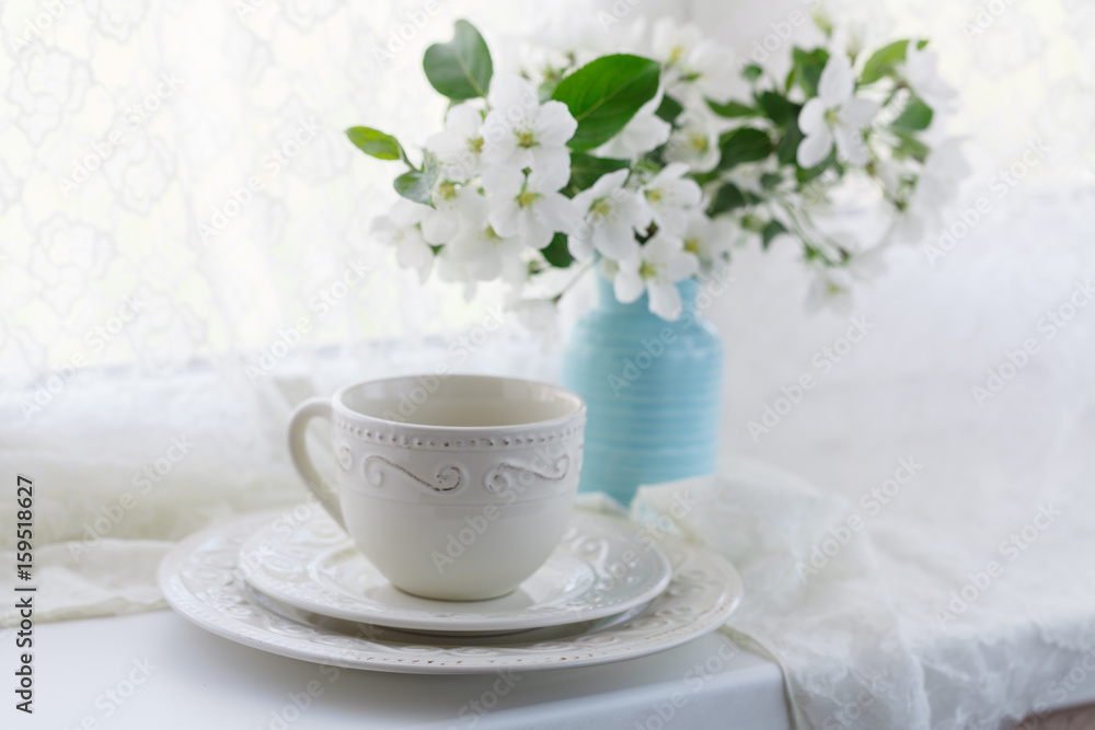 Cup of green tea and japanese cherry blossom on blue background Cup of green tea and japanese cherry blossom on blue background