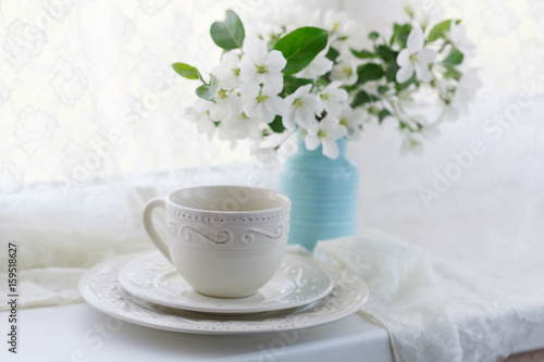 Cup of green tea and japanese cherry blossom on blue background