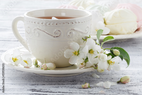 Cup of green tea and japanese cherry blossom on blue background