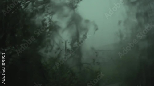 A strong hurricane outside the window, the lights go out in the apartment, the wind breaks the tree, strong wind and rain.