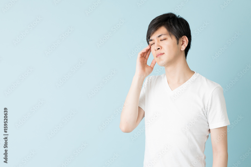 portrait of young asian man isolated on blue background portrait of young asian man isolated on blue background