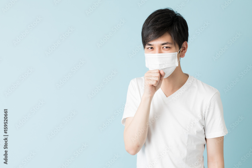 portrait of young asian man isolated on blue background portrait of young asian man isolated on blue background
