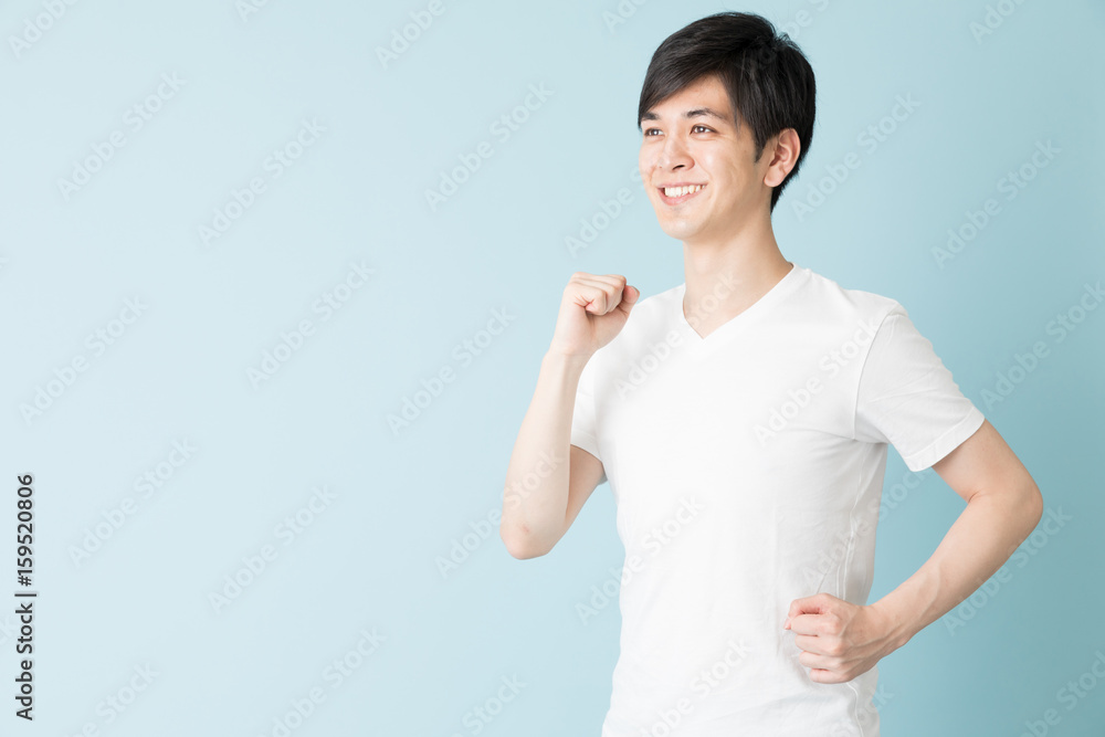 portrait of young asian man isolated on blue background portrait of young asian man isolated on blue background