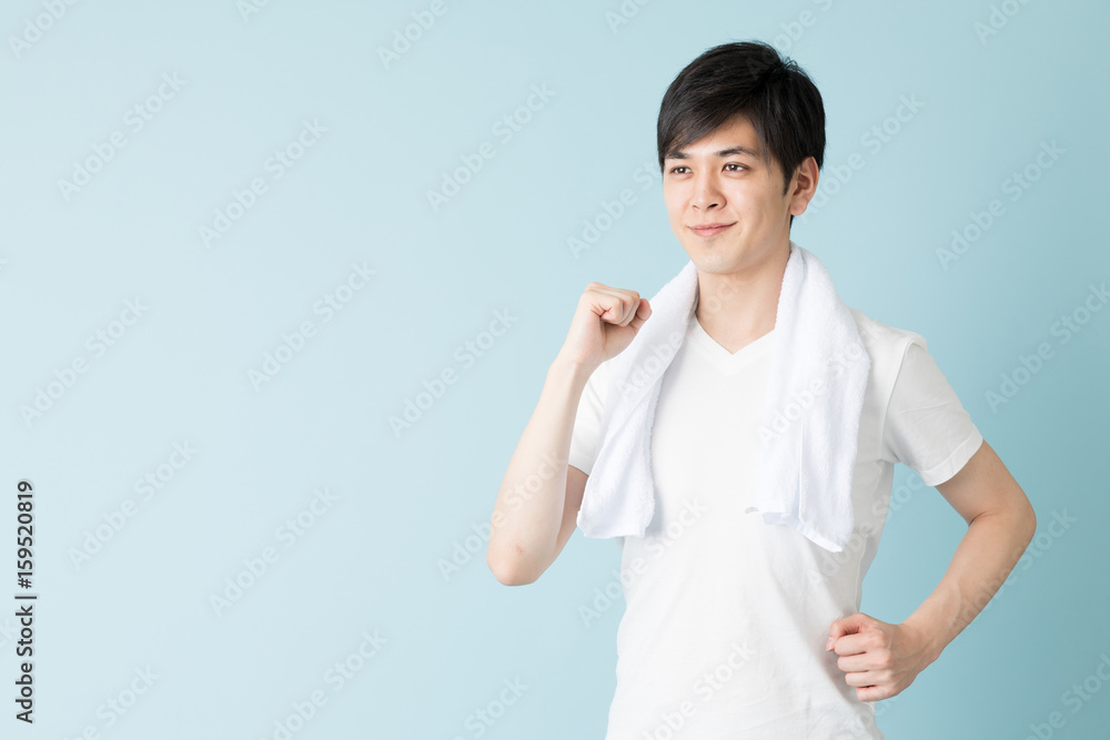 portrait of young asian man isolated on blue background portrait of young asian man isolated on blue background