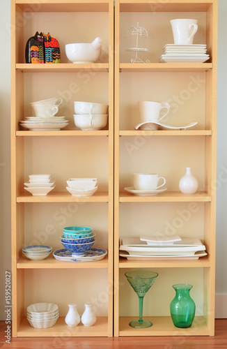 Assorted china on wooden shelves