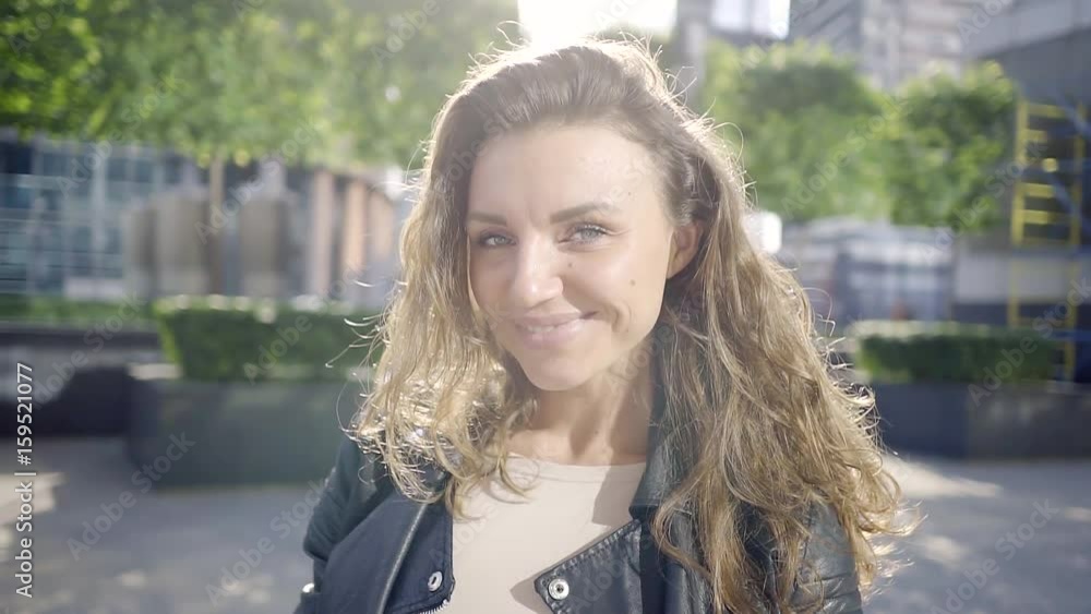 Portrait of a beautiful successful girl Manager in the courtyard office center of a big city on a Sunny spring day.