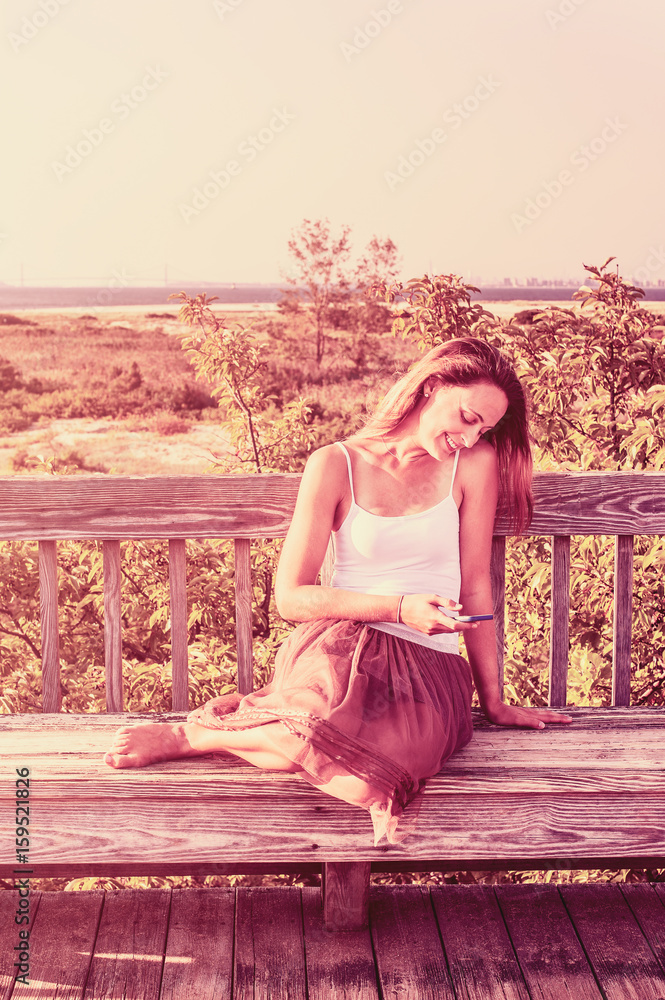 Young Woman texting on cell phone outside Young Woman texting on cell phone outside