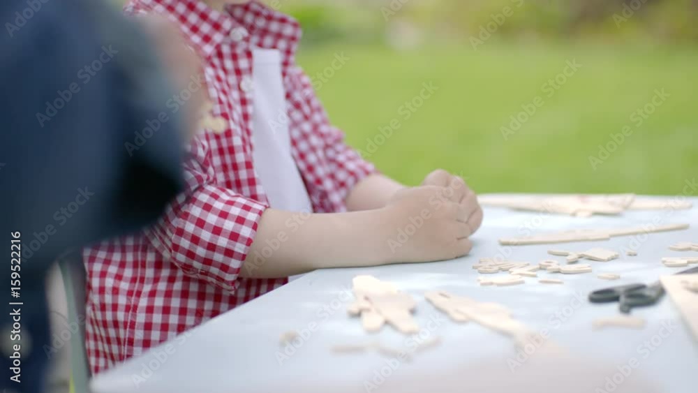 Little kid is making an wooden airplane from details Little kid is making an wooden airplane from details