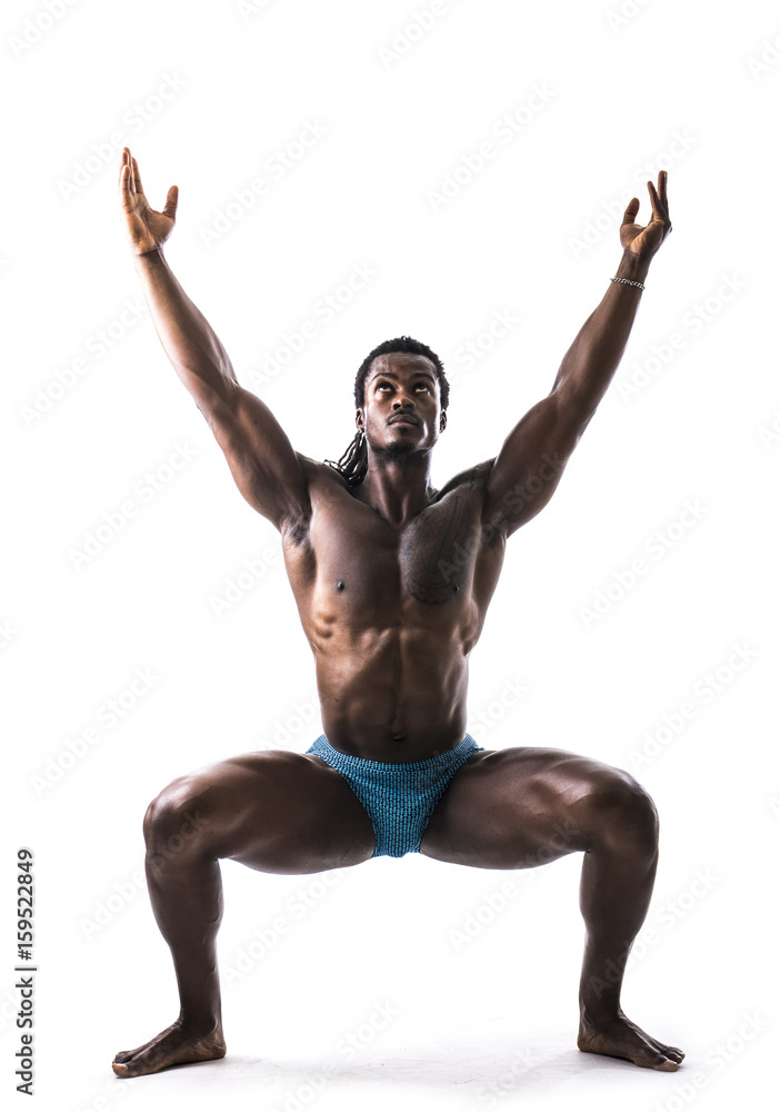 Black muscular handsome young man doing yoga exercises in studio, isolated on white background. Full body Black muscular handsome young man doing yoga exercises in studio, isolated on white background. Full body