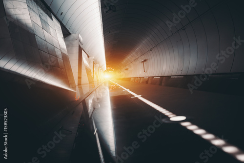 Photos Futuristic view of subway hall with railway track, illuminated restricting line,
