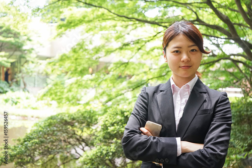 Businesswoman walking outdoors with smile