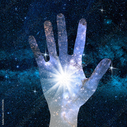 conceptual image of hand and universe