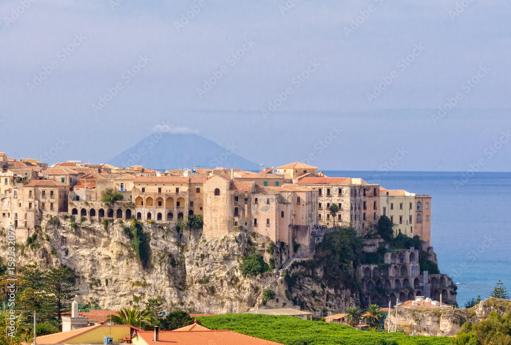 Obraz premium Tropea, a famous bathing place situated on a reef in the gulf of St. Euphemia with the Aeolian Island Lipari in the background - Calabria, Italy