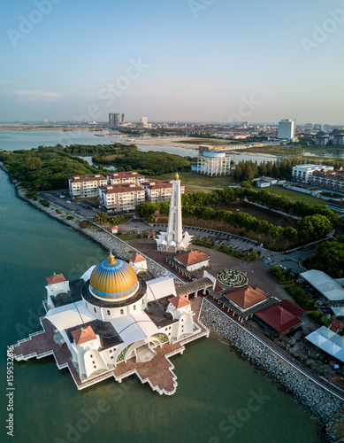Aerial Photo - Morning at a floating mosque, The Melaka Straits Mosque, located on the man-made Malacca Island near Melaka City, Melaka, Malaysia.