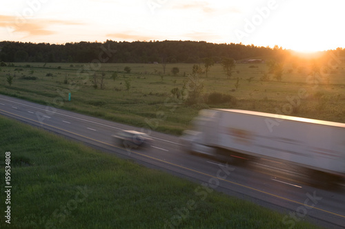 Tractor Trailer in Motion at Sunset