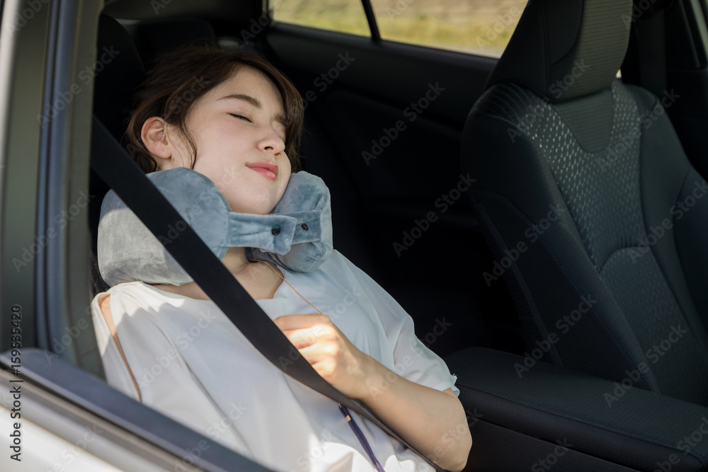 young woman sleeping in a vehicle. spending the night in a car.