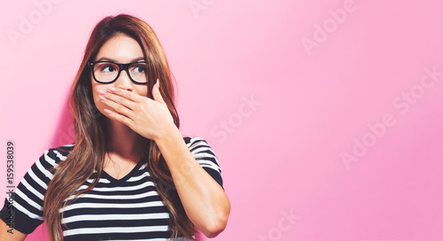 Fotografie Young woman covering her mouth