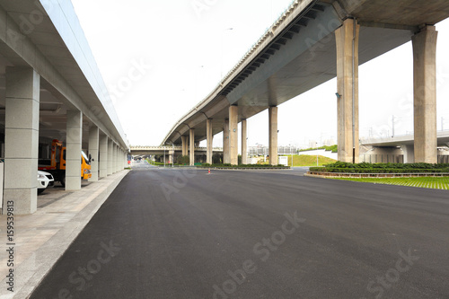 Empty road surface floor with city bridge