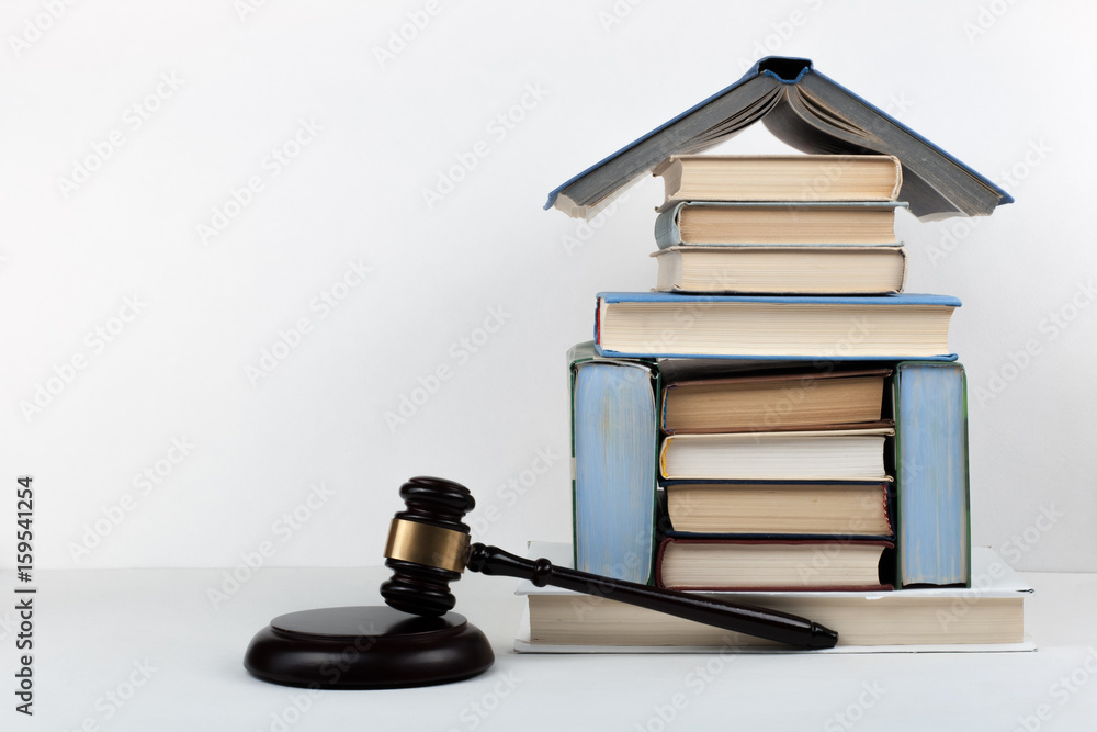 Law concept open book with wooden judges gavel on table in a courtroom or law enforcement office, white background. Copy space for text. Law concept open book with wooden judges gavel on table in a courtroom or law enforcement office, white background. Copy space for text.