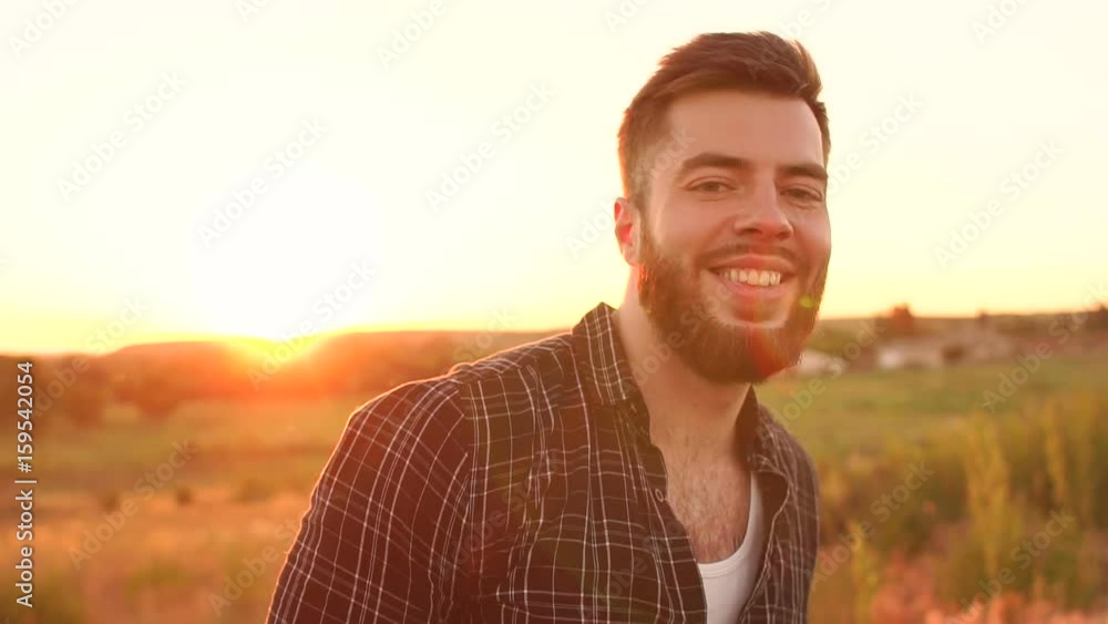 Portrait of the young bearded man on sunset background. Portrait of the young bearded man on sunset background.