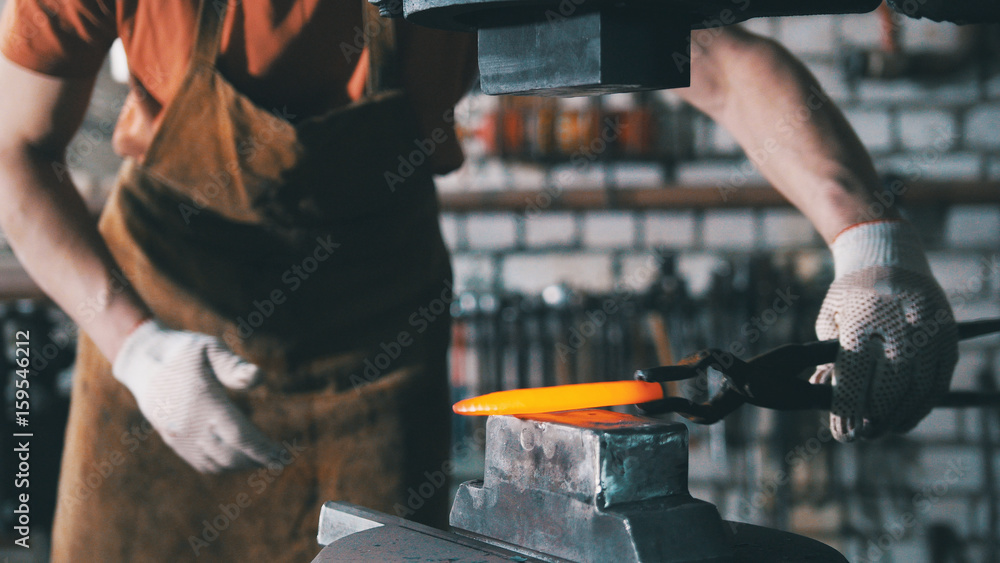 Automatic mechanical hammering - blacksmith forging red hot iron on anvil, telephoto Automatic mechanical hammering - blacksmith forging red hot iron on anvil, telephoto